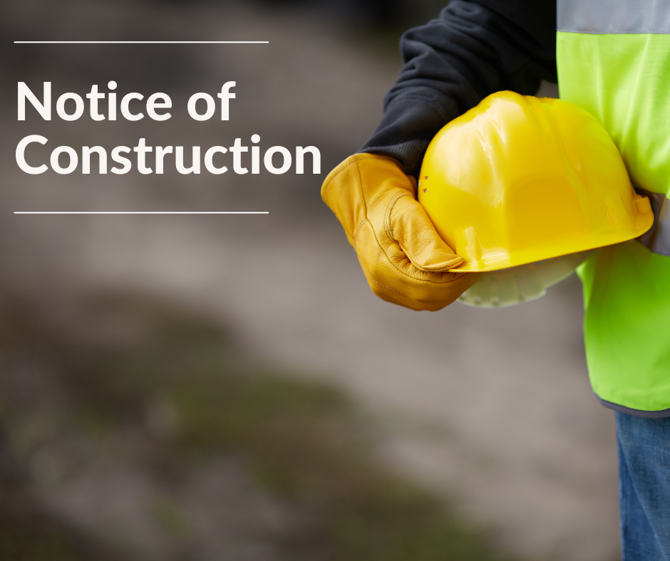 Man holding a hard hat. txt reads notice of construction 