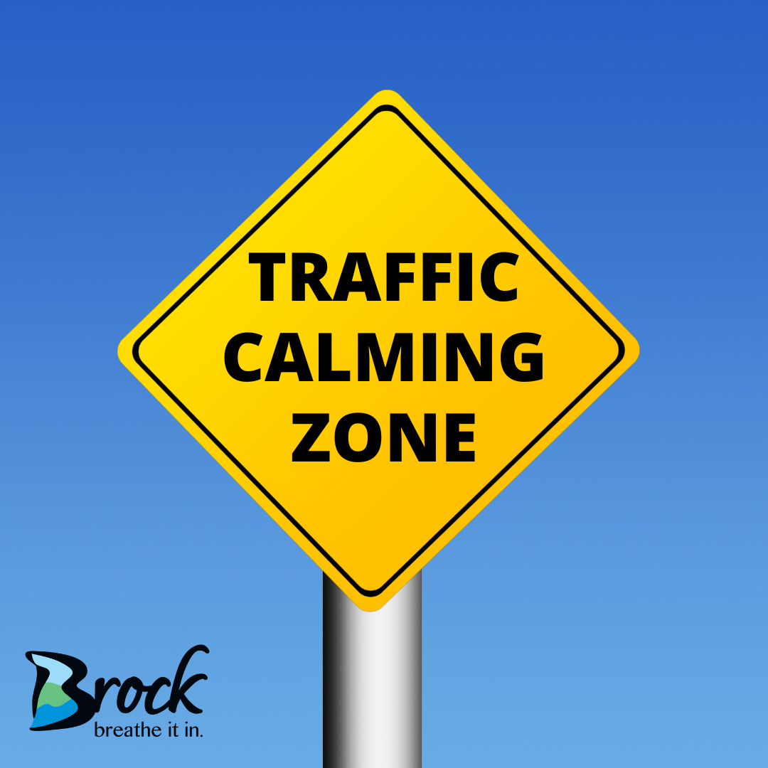 yellow traffic sign reading traffic calming zone