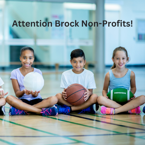 kids in a gym holding various sport balls