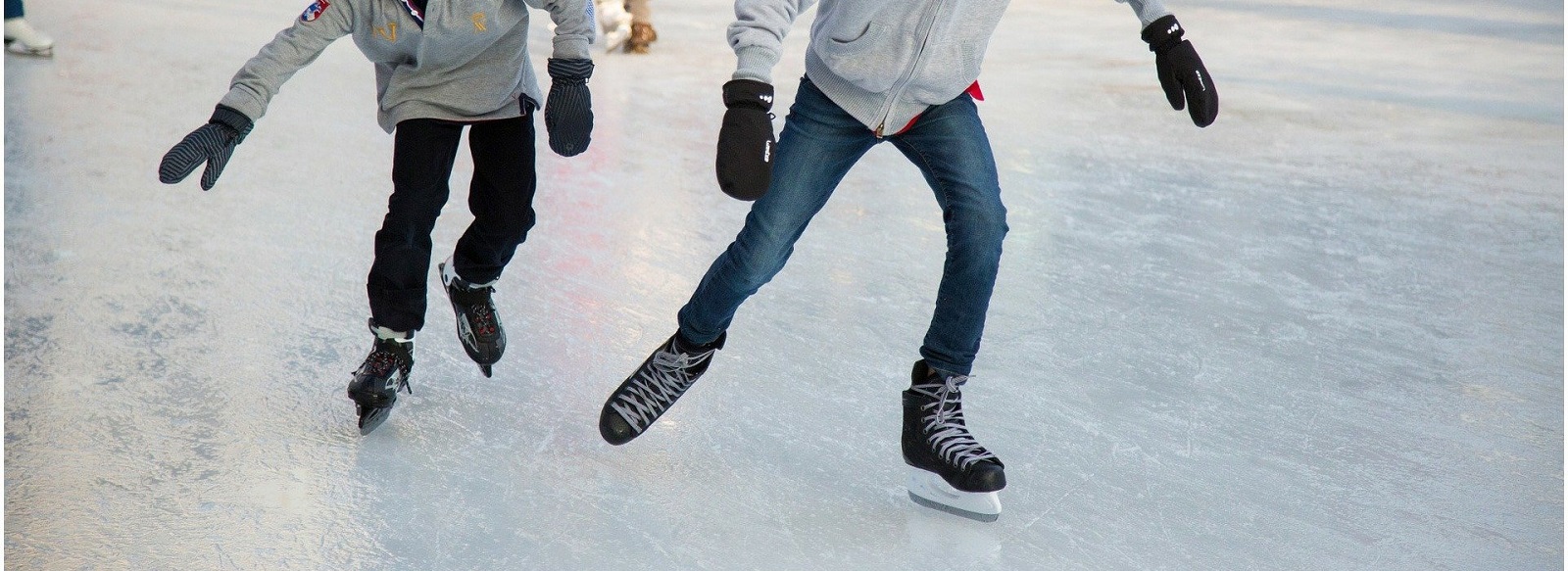 Two people skating on ice